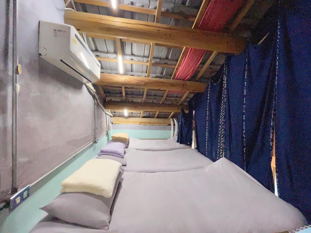Postel nebo postele na pokoji v ubytování Fuqi Hostel - Heping