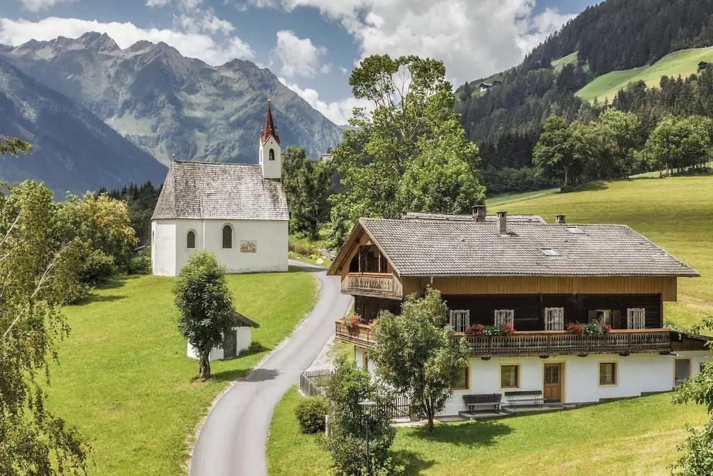 a church on a hill next to a road at Ferienhaus Oberschneider in Selva dei Molini