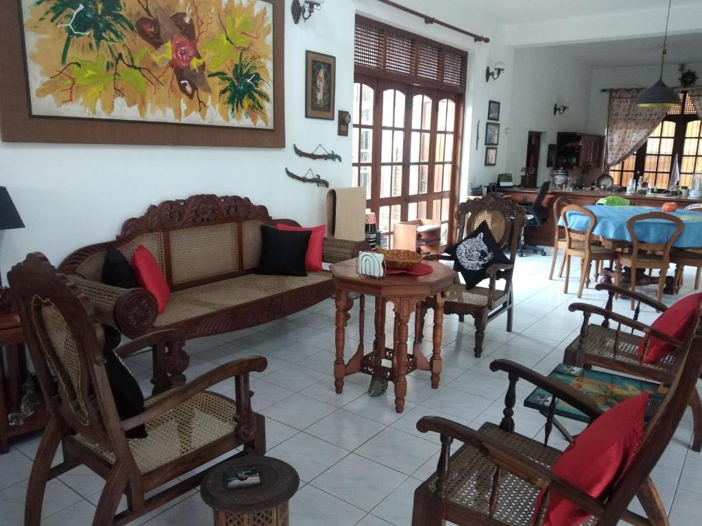 a living room with a couch and tables and chairs at Roche's Cozy Corner R-2 Ground Level in Sri Jayewardenepura Kotte