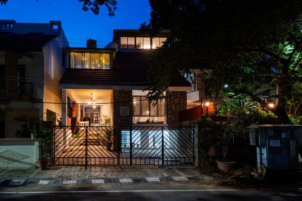 a house with a gate in front of it at night at BYOC Hostels in Bangalore
