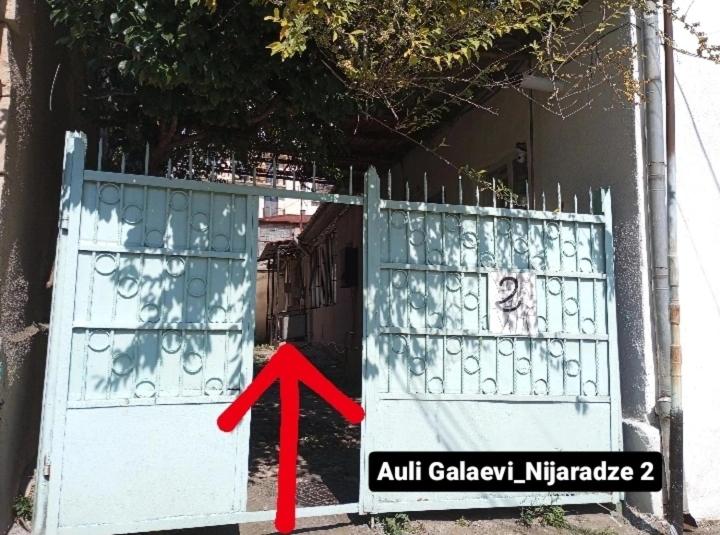 an open gate with a red arrow pointing to an exit at Jacquard Apartment in the centre of Kutaisi in Kutaisi