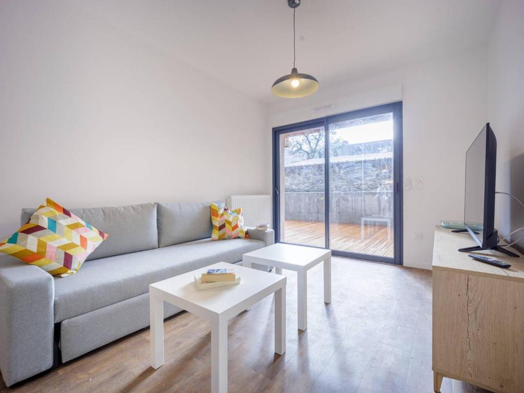 a living room with a couch and a table at Appartement Loudenvielle, 3 pièces, 6 personnes - FR-1-695-17 in Loudenvielle