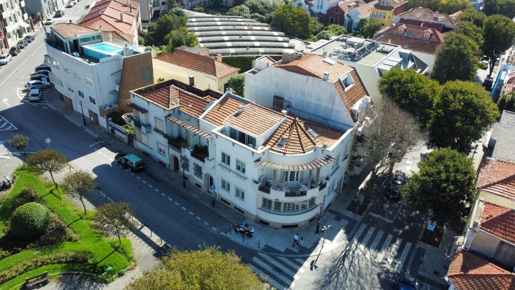 an overhead view of a large white building on a city street at Suites Foz O Porto in Porto