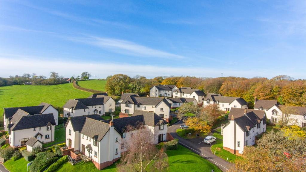 an aerial view of a residential neighborhood with houses at Woodford Bridge Country Club in Milton Damerel