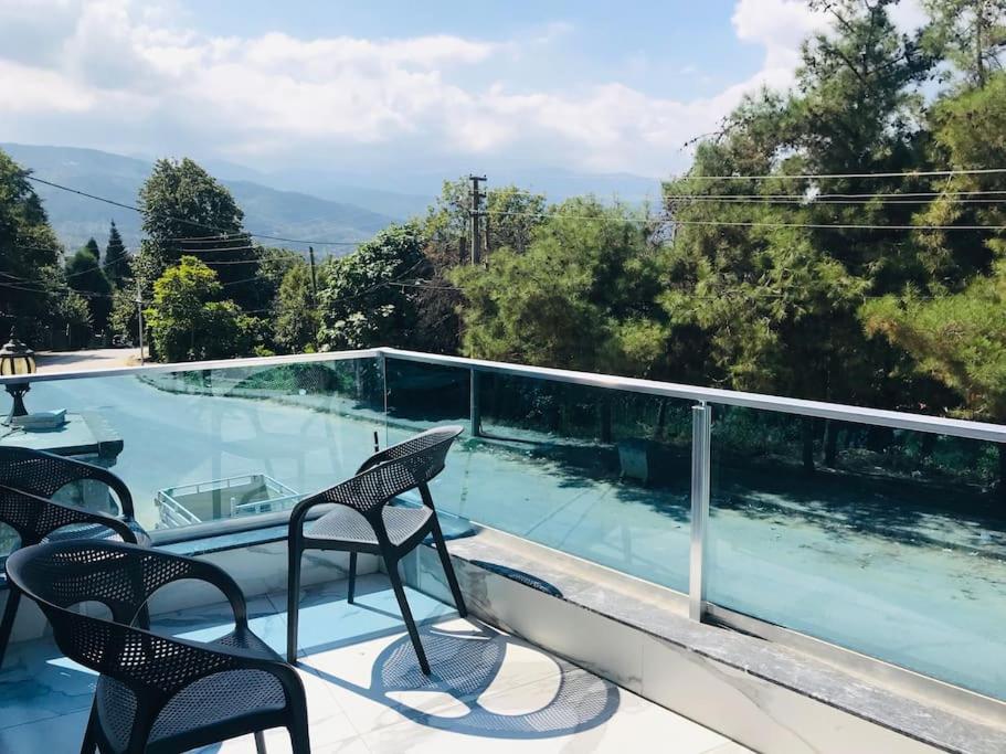 a balcony with chairs and a swimming pool at Sapanca Villa View Suite in Sapanca