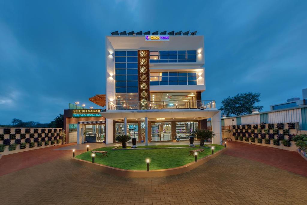 a large building with a lawn in front of it at Click Hotel Sagar Plaza Chakan, Pune in Chakan