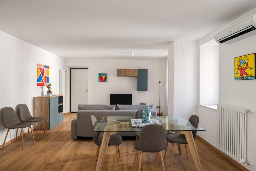 a living room with a glass table and a couch at Little House Mavi by DomuSicily in Palermo