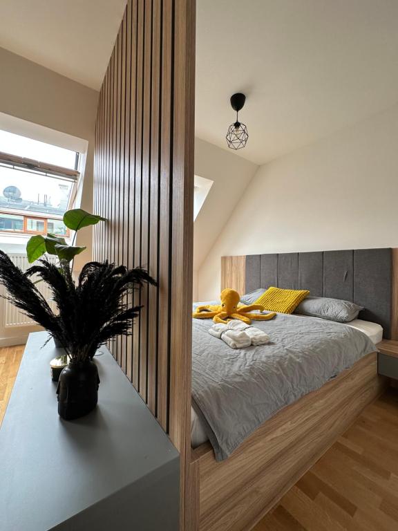 a bedroom with a bed and a plant on a table at The presidential studio in Bratislava