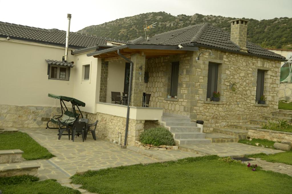 a stone house with a porch and a patio at Persefoni's Home in Ioannina