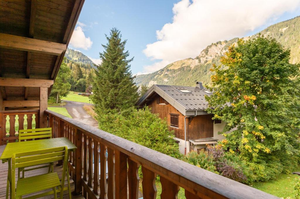 a balcony of a cabin with a view of the mountains at Casa Linga - Chalet - BO Immobilier in Châtel