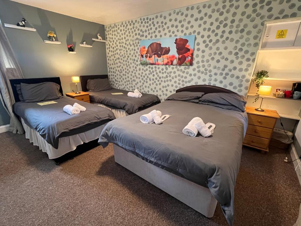 a bedroom with two beds with towels on them at SELF Check In Room Accommodation ONLY The Castle, Coldstream in Coldstream