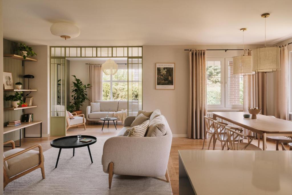 a living room with a couch and a table at Villa Saltic in Grzybowo