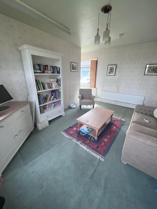 a living room with a couch and a coffee table at Newera Farm in Canley