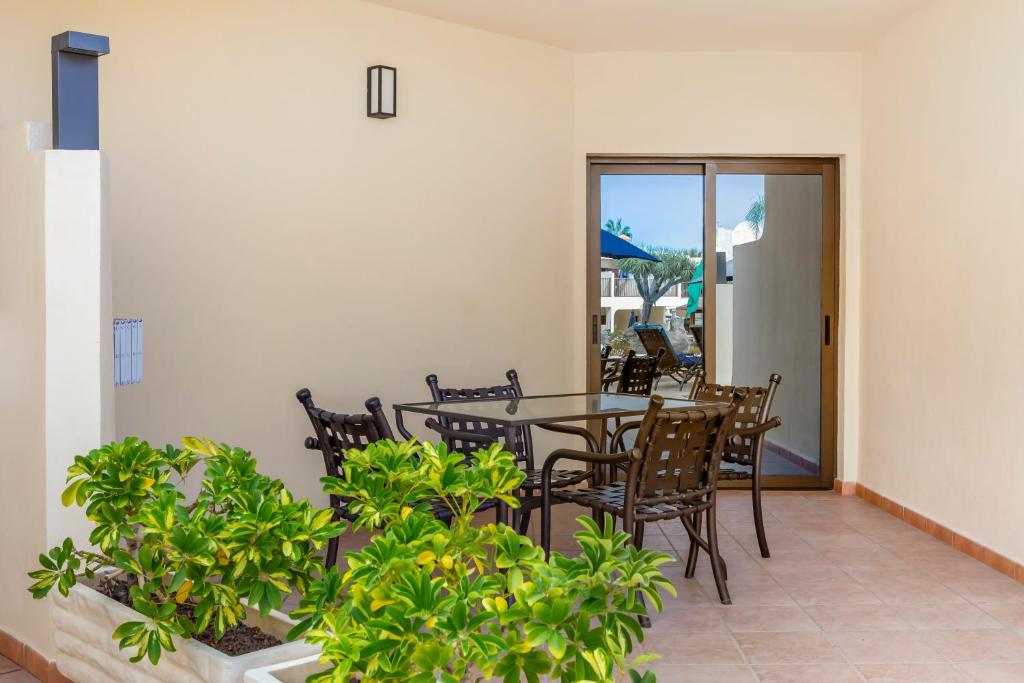 a patio with a table and chairs and plants at Royal Sunset Beach Club in Adeje