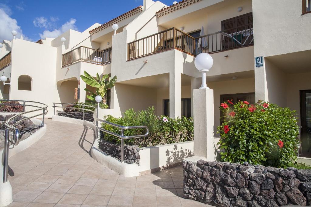 a view of a building with flowers and plants at Royal Sunset Beach Club in Adeje