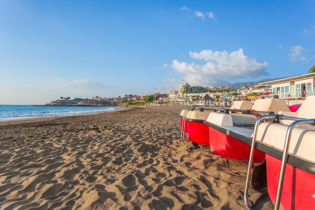 a group of boats sitting on a sandy beach at Royal Sunset Beach Club in Adeje