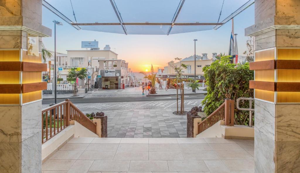 a view of a city street with the sun setting at Royal Sunset Beach Club in Adeje