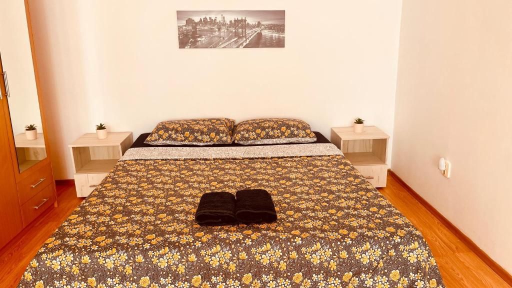 una camera da letto con un letto e due pantofole sopra di C-House Inchiriaza Apartament 2 Camere in Regim Hotelier a Râmnicu Vâlcea