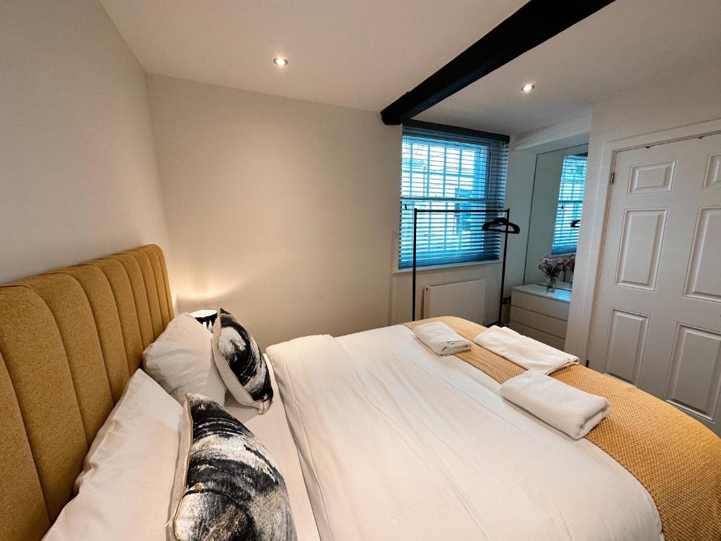 a bedroom with a bed with a dog on it at 73A Weavers House - Mountergate in Norwich
