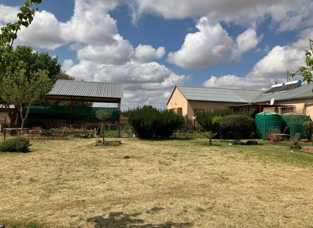 a yard with a building and a gazebo at New Joy in Bloemfontein