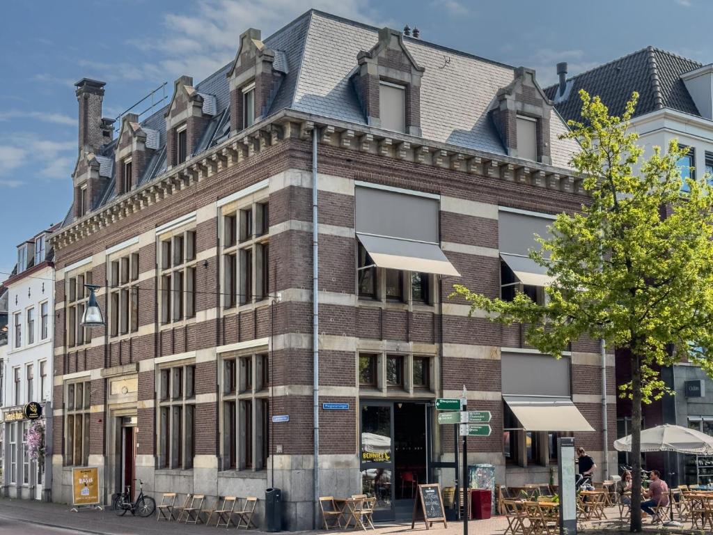 a large brick building on the corner of a street at Hostel & Bar De Basis in Zwolle