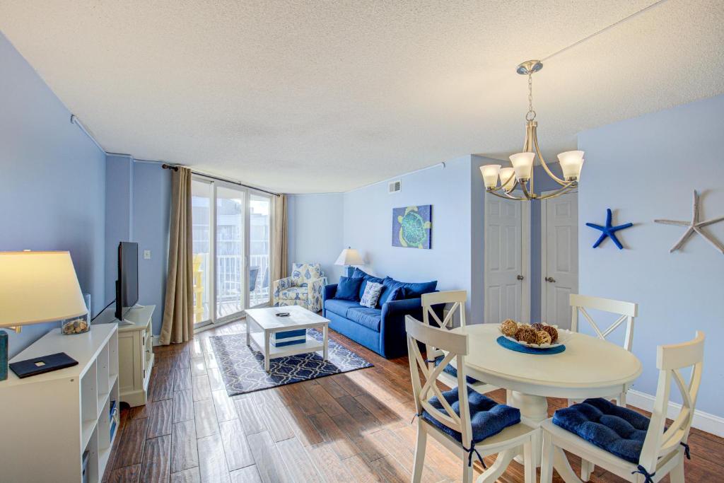 a living room with a table and a couch at NTBSR3404 St Regis 3404 in North Topsail Beach