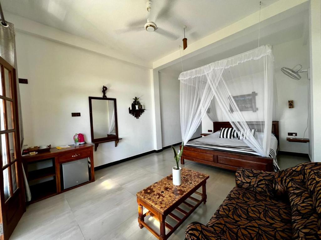 a living room with a bed and a couch at Eagle View villa in Ella