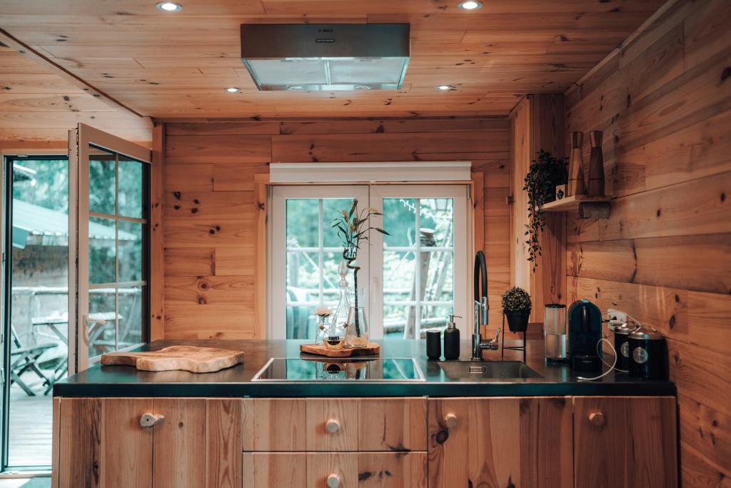 a kitchen with wooden walls and a counter top at Wooden Nest in Durbuy