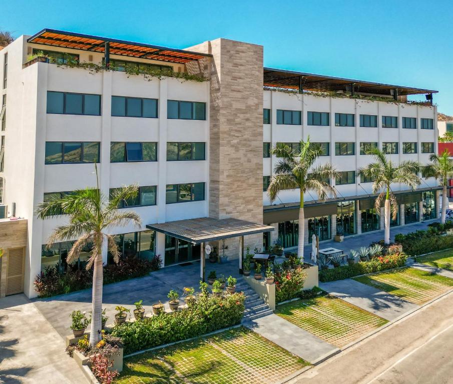 an aerial view of a white building with palm trees at Gamma Los Cabos in San José del Cabo