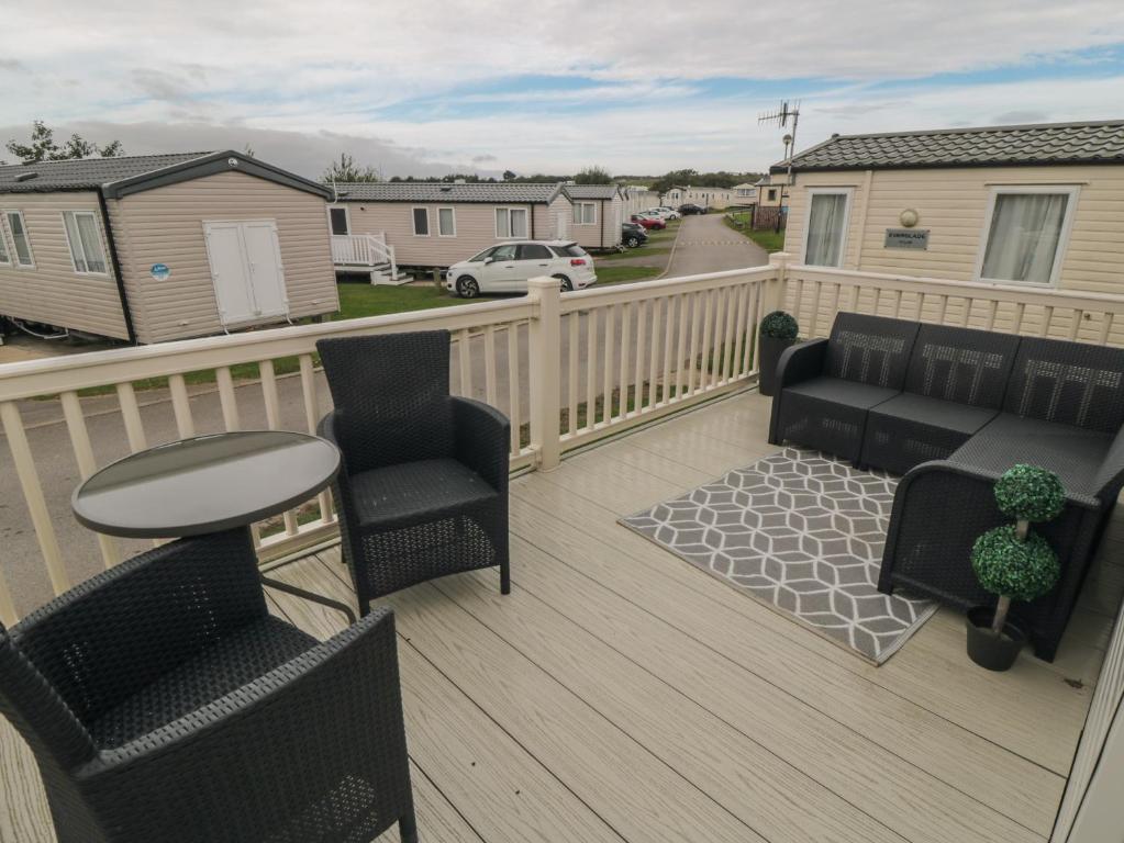 a balcony with chairs and a table on a deck at No30 Elm Rise in Filey