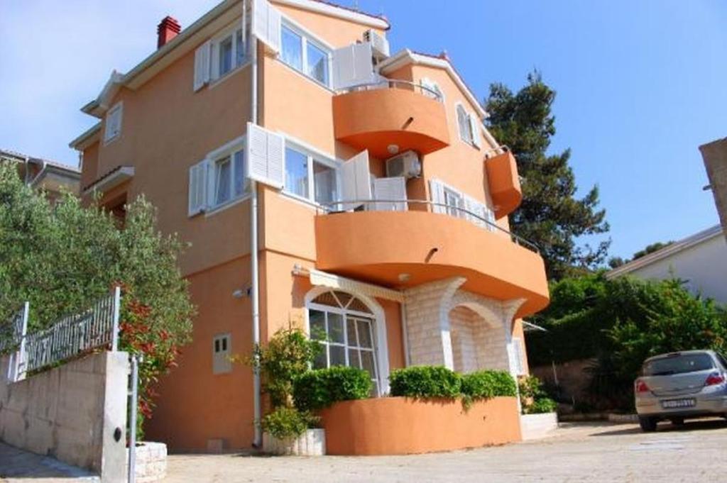 a large orange building with a balcony at Apartment in Zaboric with sea view, balcony, air conditioning 5178-3 in Šibenik