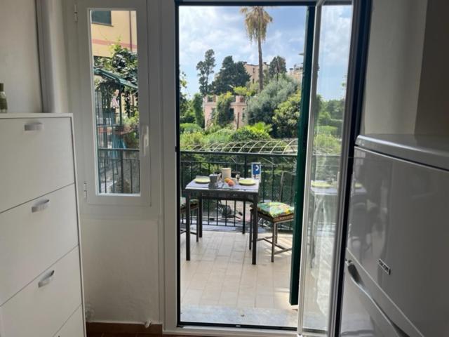 a kitchen with a view of a patio with a table at A DUE PASSI DAL MARE in Genova