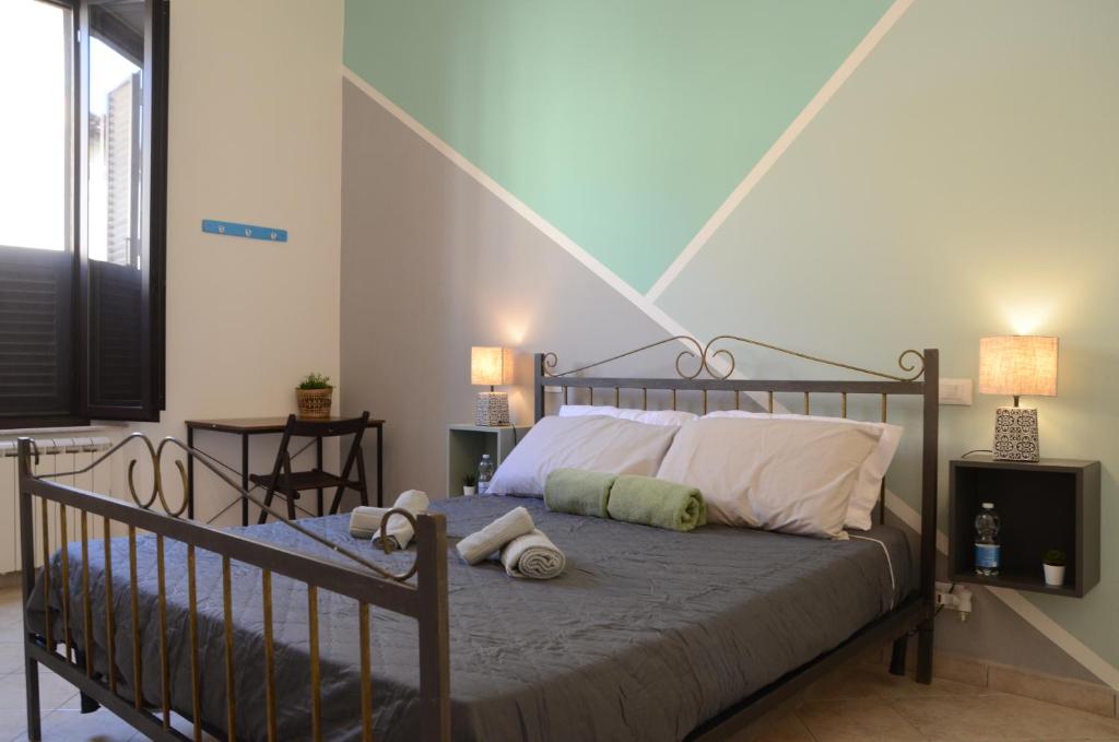 ein Schlafzimmer mit einem Bett mit zwei Kissen darauf in der Unterkunft La finestra sul viale in Pisa