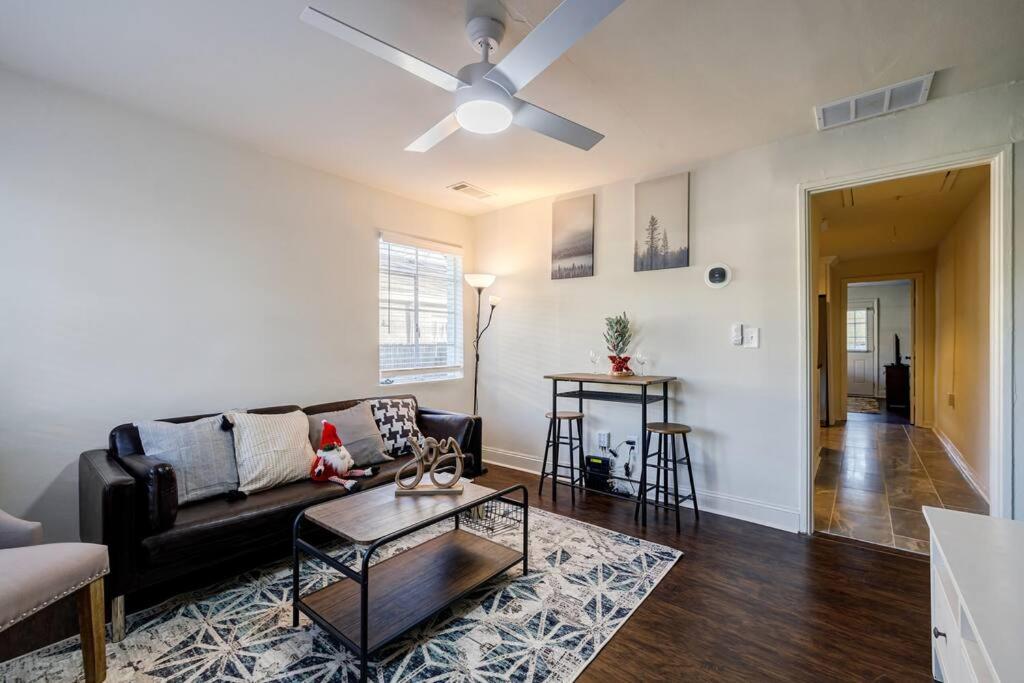 a living room with a couch and a table at 5 min Grant park with Fenced Yard Parking Pet Friendly in Atlanta