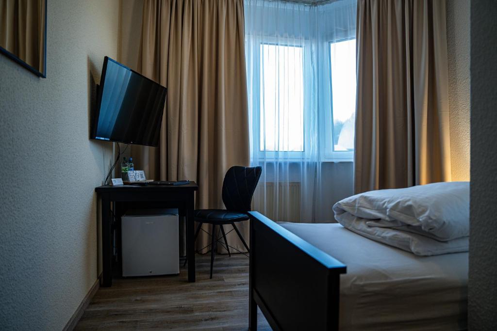 TV a/nebo společenská místnost v ubytování E&D Hotel Rodgau