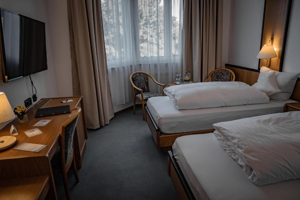 Postel nebo postele na pokoji v ubytování E&D Hotel Rodgau
