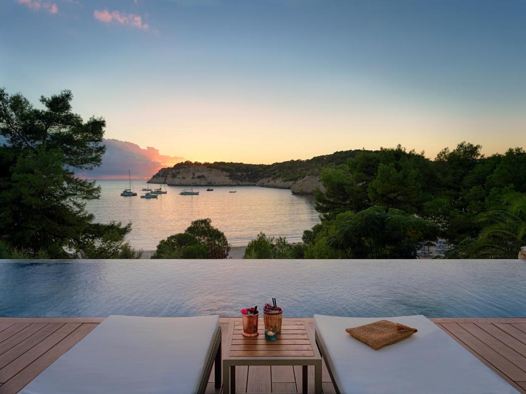 a balcony with a view of a body of water at Meliá Cala Galdana in Cala Galdana