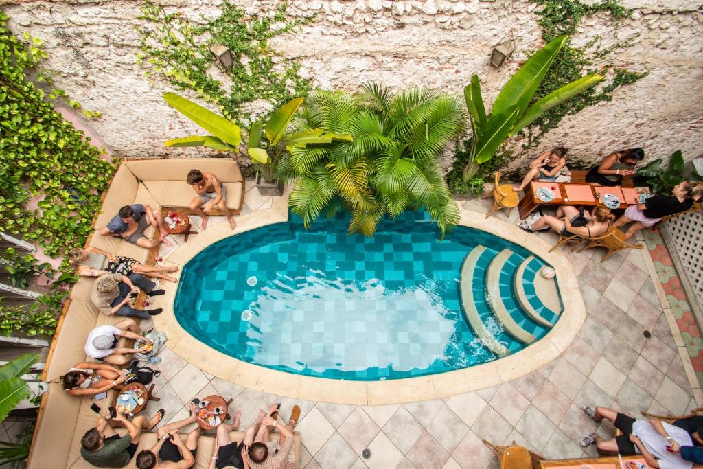 an overhead view of people sitting around a swimming pool at Casa Zahri Boutique Hostel in Cartagena de Indias