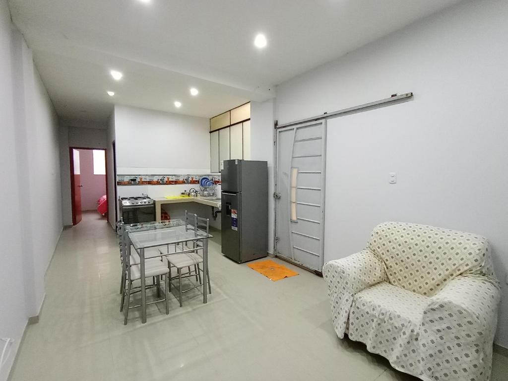 a kitchen with a couch and a table and a chair at O'CALA HOUSE in Huánuco