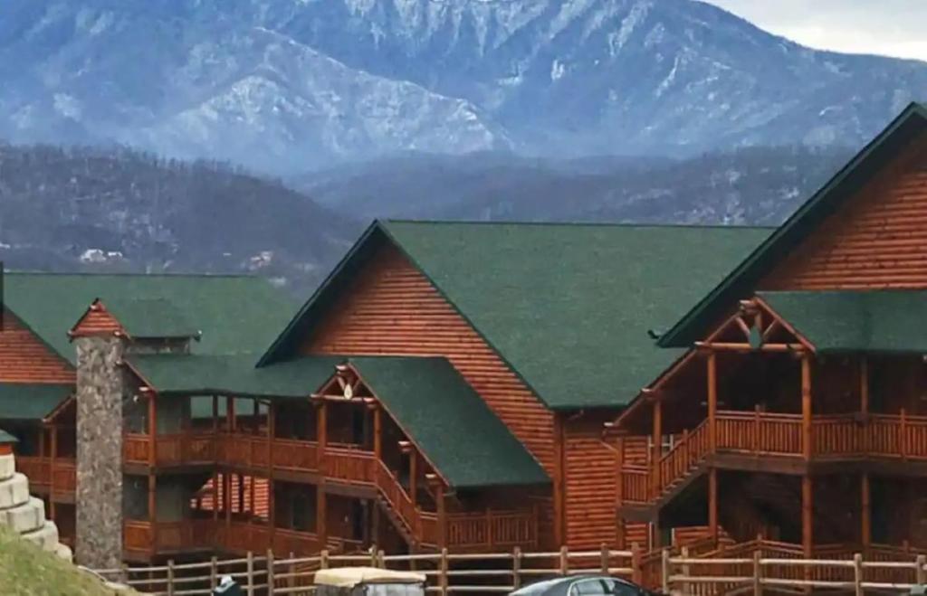 a log cabin with mountains in the background at Westgate Smoky Mountain Resort & Water Park in Gatlinburg