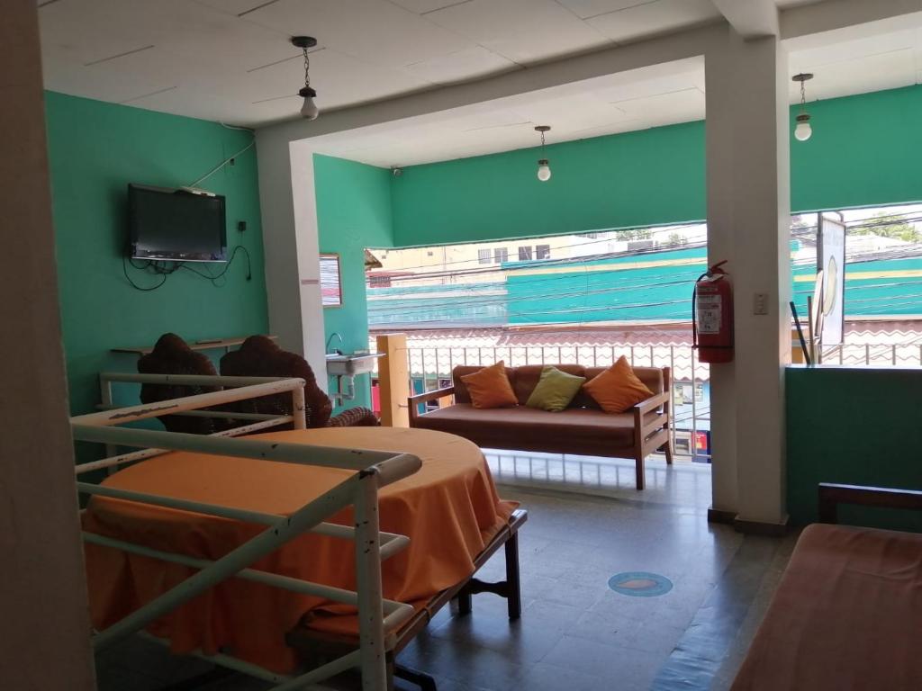 a hospital room with two bunk beds and a couch at Hotel Mango Cafe in Tela