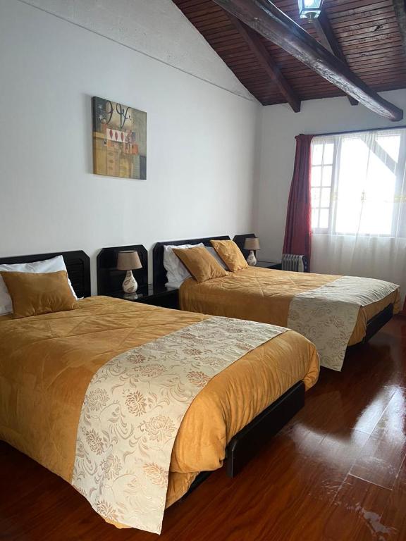 Postel nebo postele na pokoji v ubytování Quinta Hotel Las Buganvillas