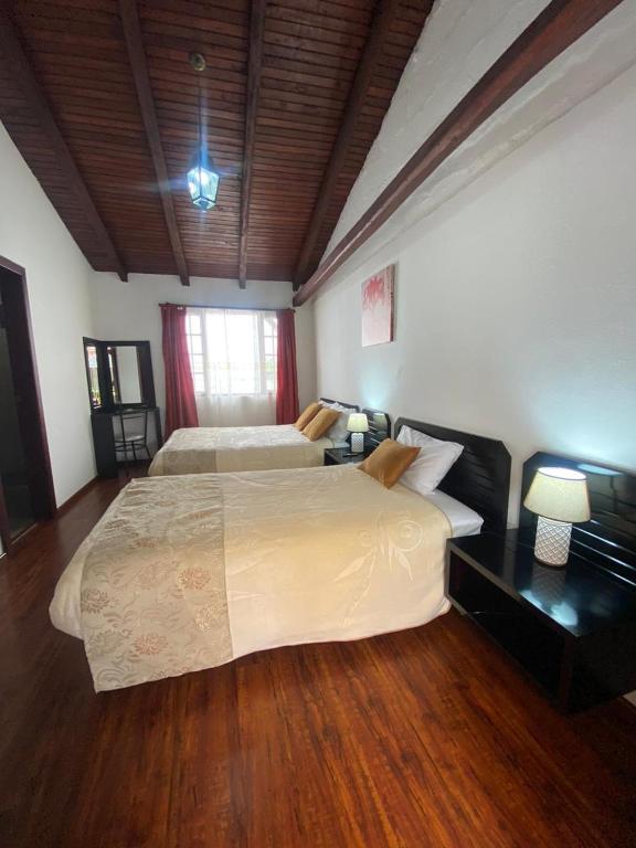 Postel nebo postele na pokoji v ubytování Quinta Hotel Las Buganvillas