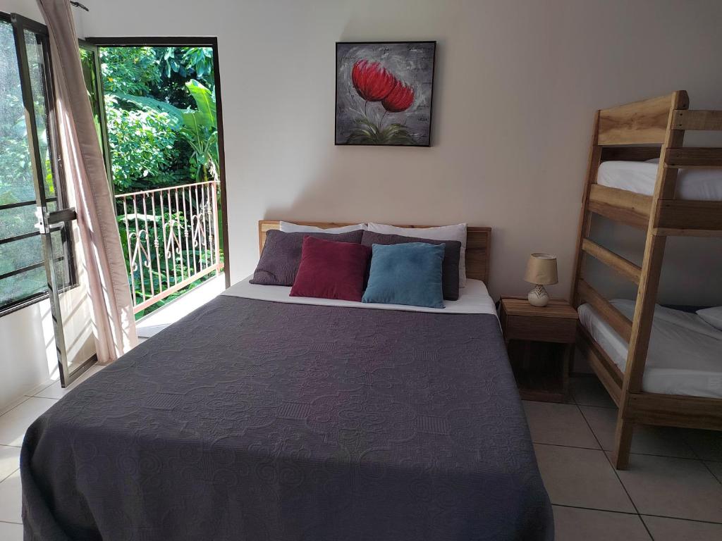 a bedroom with a bed with pillows on it at Casa Palmera Cocles, 300m to the beach in Puerto Viejo