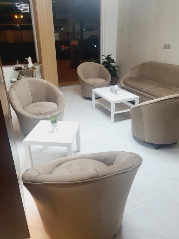 a living room with couches and chairs and tables at دانة الفخامه للشقق الخدومة in Tabuk