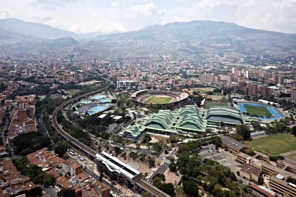 an overhead view of a city with a train on the tracks at Penthouse-Loft, Laureles, Vistas a Medellín - 801 in Medellín