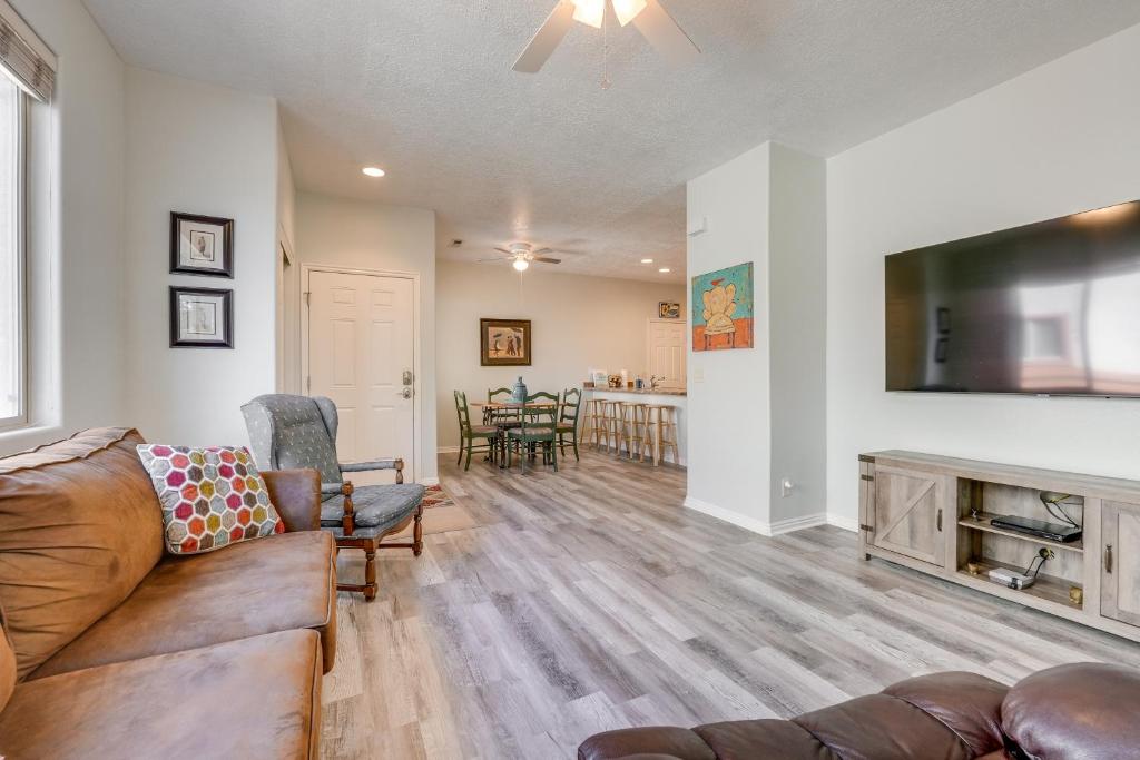 a living room with a couch and a flat screen tv at Mesquite Vacation Rental Condo with Community Pool! in Mesquite