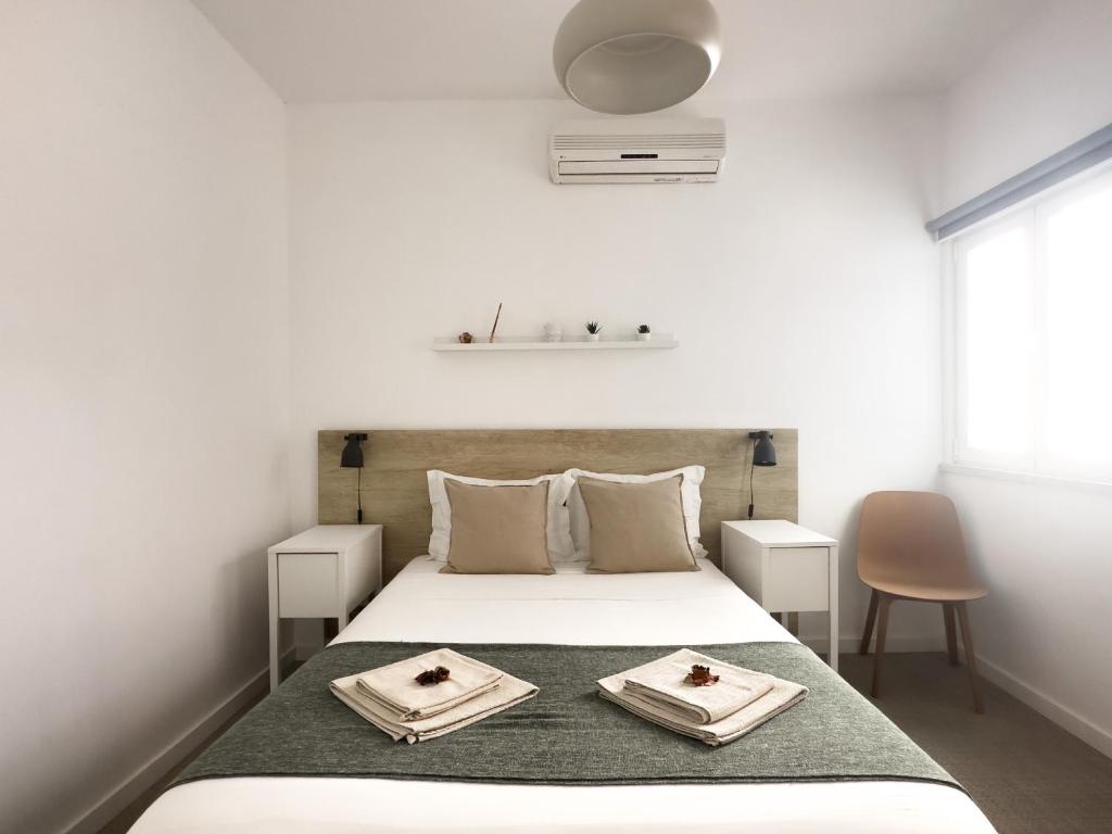 a bedroom with a bed with two plates on it at Solar do Alentejo in Cercal