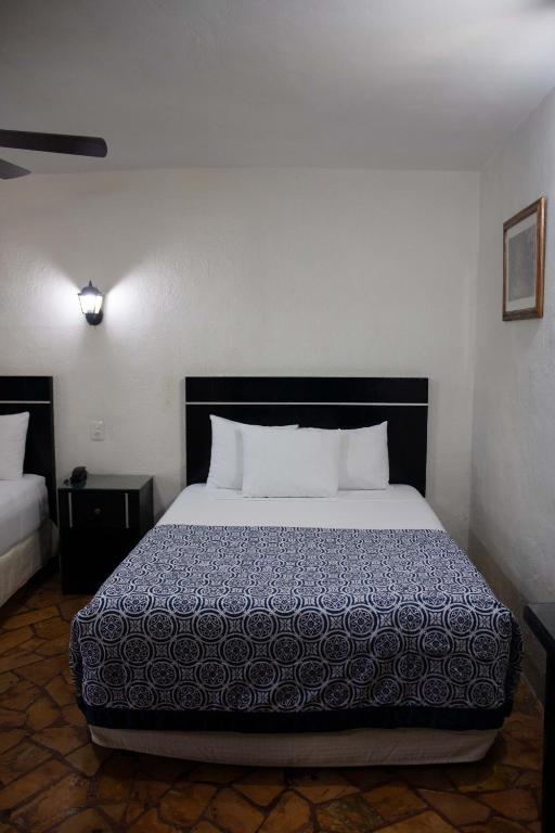 Postel nebo postele na pokoji v ubytování Hotel Santa Ana