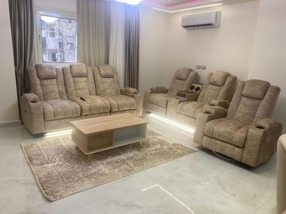 a living room with two couches and a coffee table at شقة المهندسين جامعة الدول ميدان لبنان الدقي مميز in Cairo